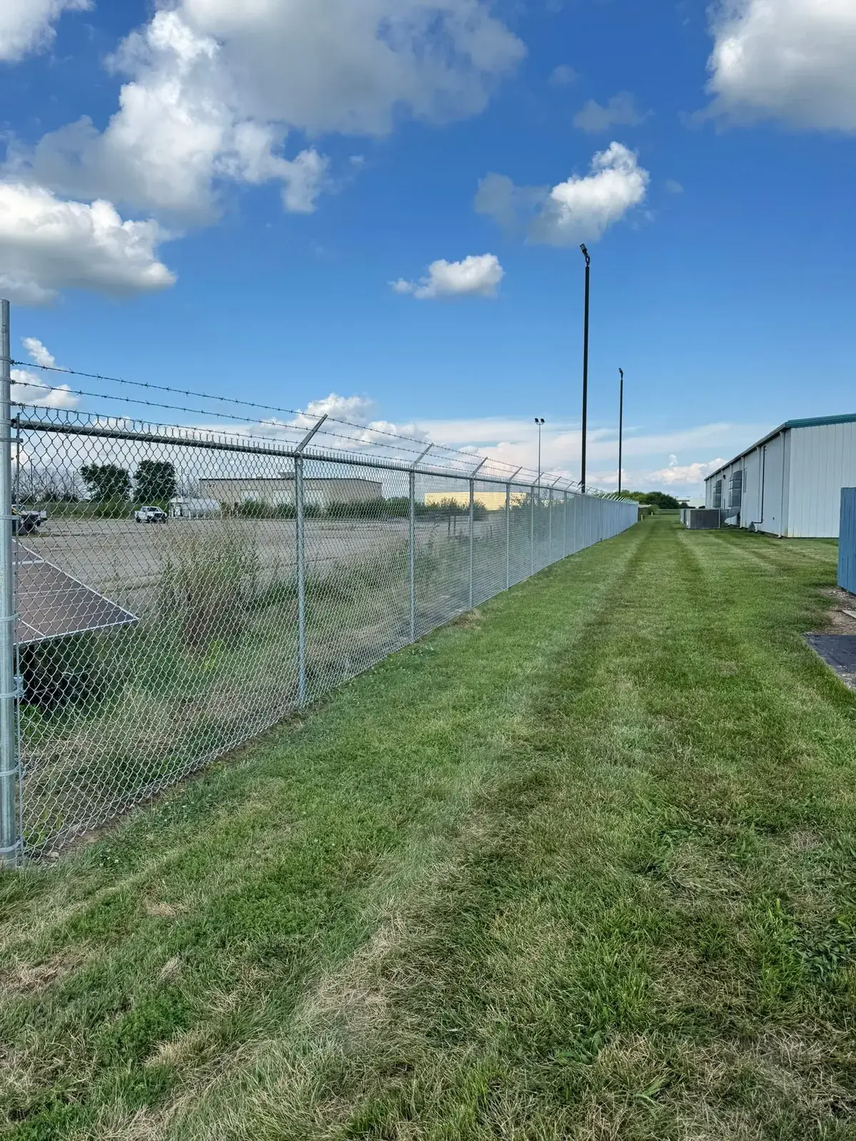 Commercial chain-link fence with barbed wire