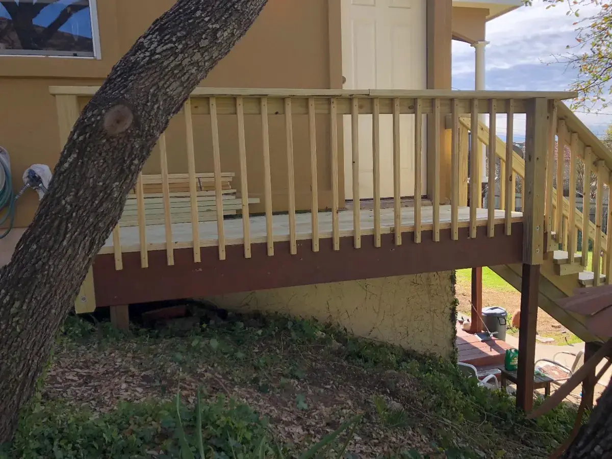 Elevated wood deck build with railing