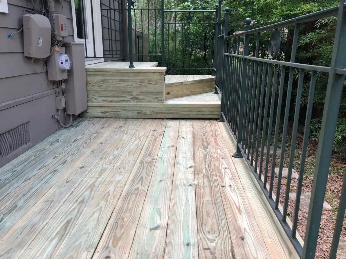 New wood deck steps with an iron rail