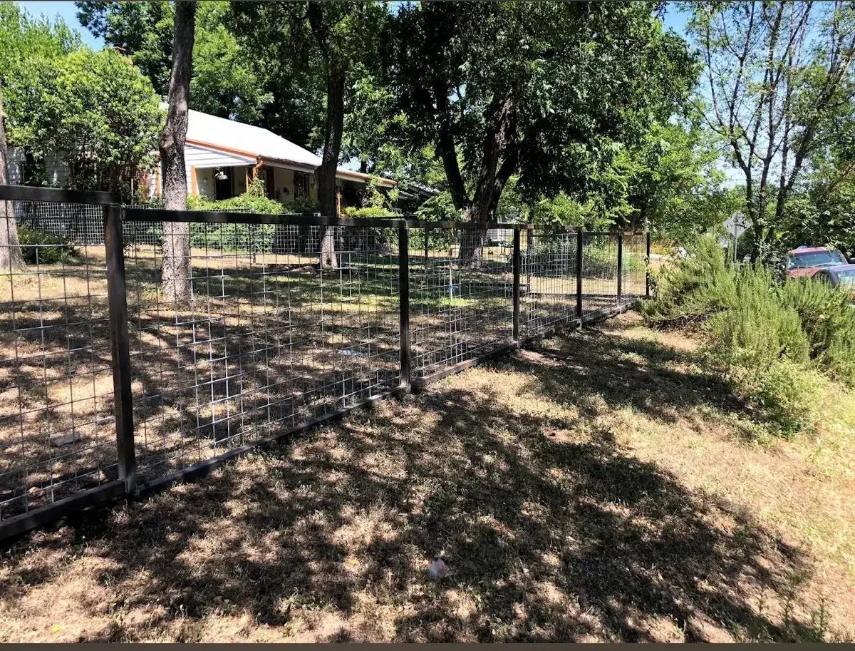 Black steel-frame cattle panel fence