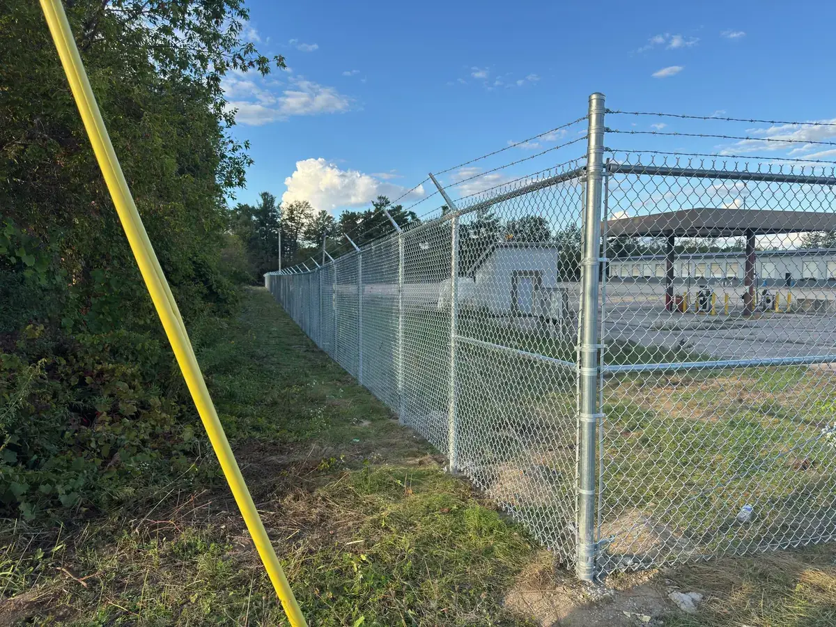 Commercial chain-link fence with barbed wire