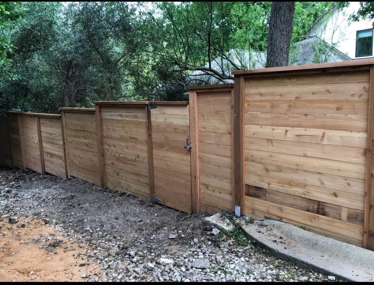 Horizontal cedar fence line on a graded lot