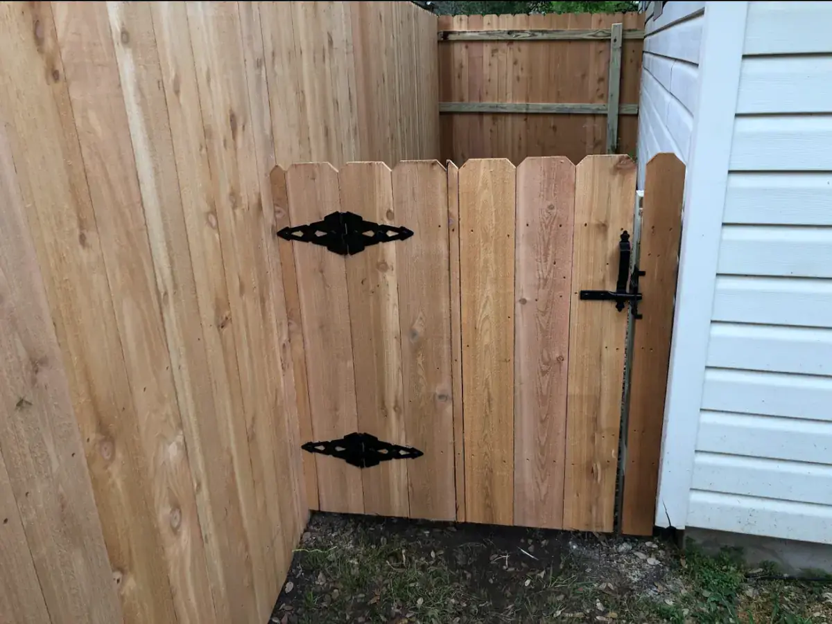 Cedar walk gate with decorative black hardware